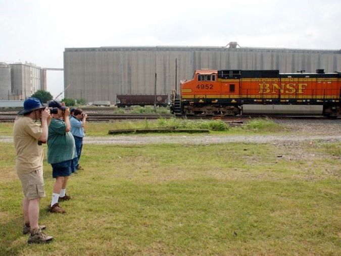 Railfans enjoy train spotting from a safe distance outside of railroad property during a 24 Hours at Saginaw event at the Saginaw Interlocker.